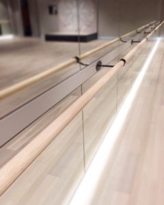 Close up image of the timber barre against the mirrors