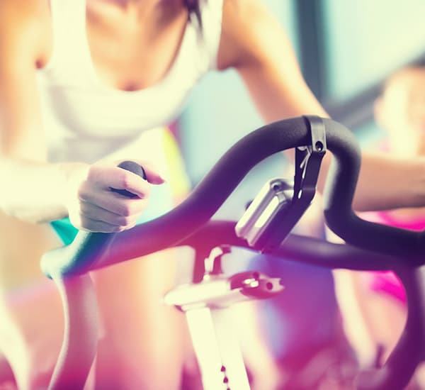 A women on a bike in a cycle class.