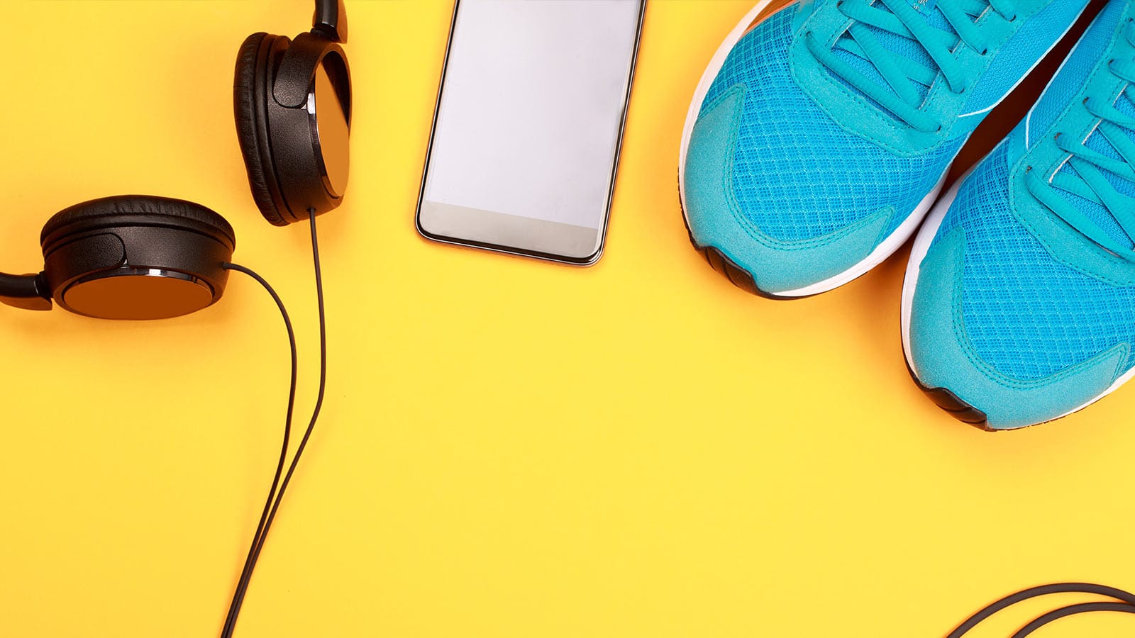 head phones and running shoes flatlay
