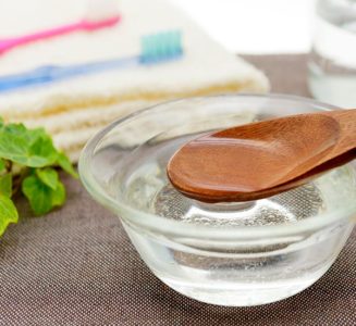 Melted coconut oil on a wooden spoon